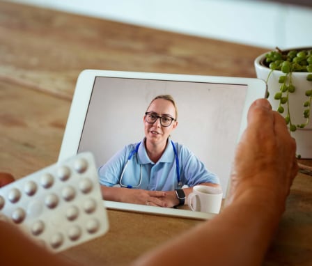 Work from home nurse on video call with patience