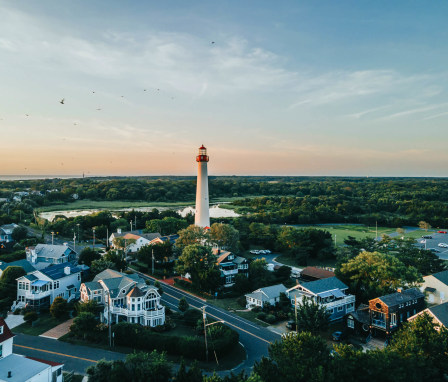 Lighthouse and surrounding homes in Cape May, New Jersey, at sunset