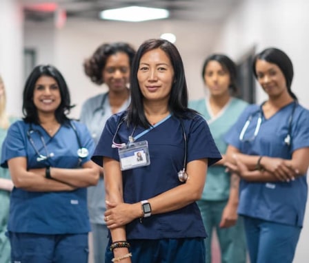 Team of nurses standing in hallway