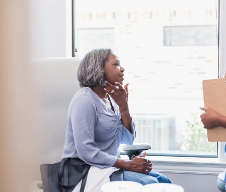 Senior patient speaking with dermatology nurse