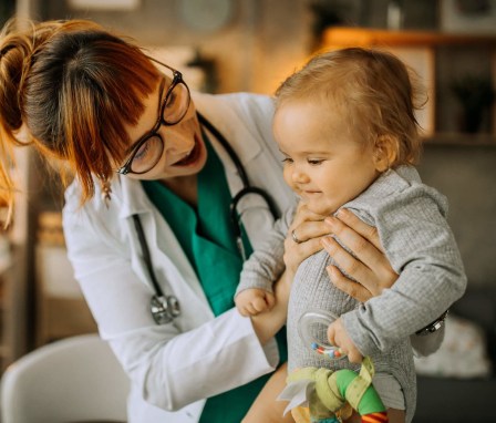 Pediatric Nurse Practitioner tending to baby