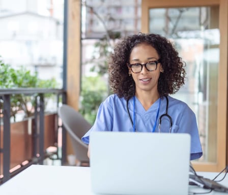 Medical coder on laptop