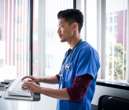 Asian male nurse using computer