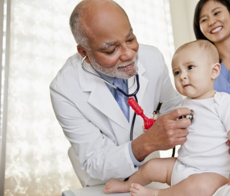 Doctor examining baby's heartbeat