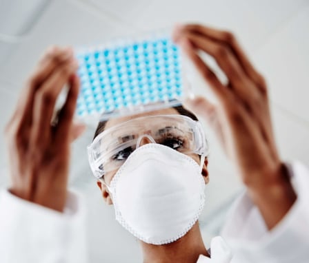 Nurse examining laboratory samples