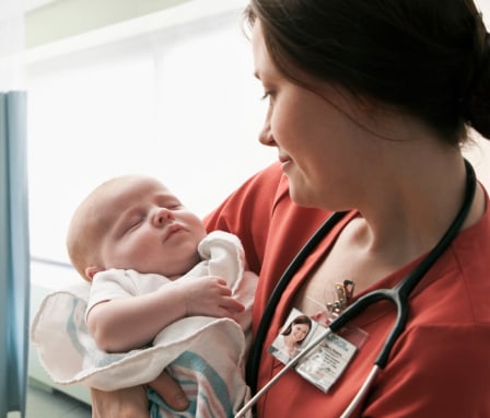 Nurse holding newborn