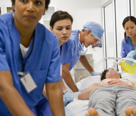 Nurses and doctor working together on a patient lying down