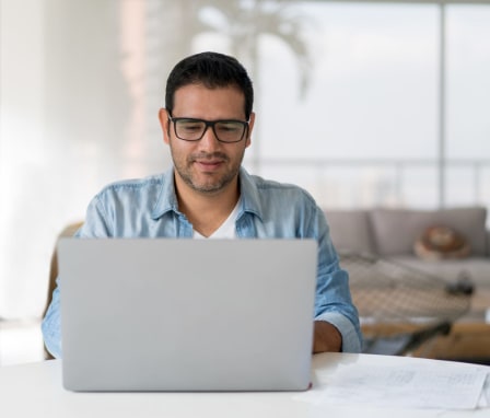 Man typing on laptop at home