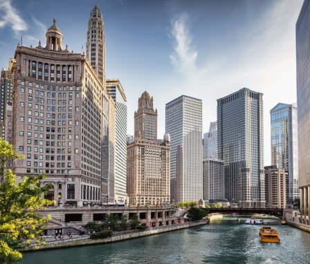 A city tour boat cruising on the Chicago River through downtown Chicago, Illinois.