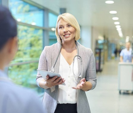 Two people talking in hospital hallway