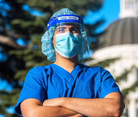 Healthcare worker standing in front of a capitol building