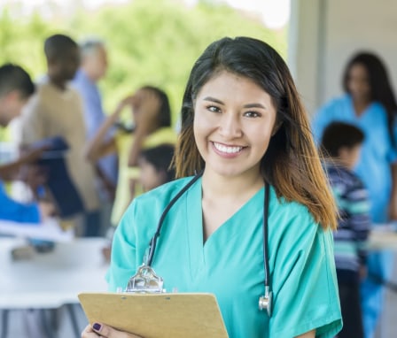 Nurse working at a public health clinic holding a clipboard