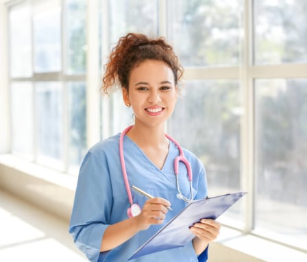 Young African-American nurse working in a clinic. Image Credit: Pixel-Shot / African / Shutterstock