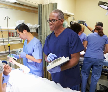 Team of nurses examining a patient in the emergency room. Image Credit: Monkey Business Images / Shutterstock