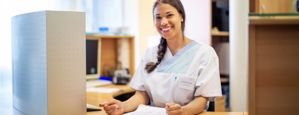 Medical assistant sitting at desk