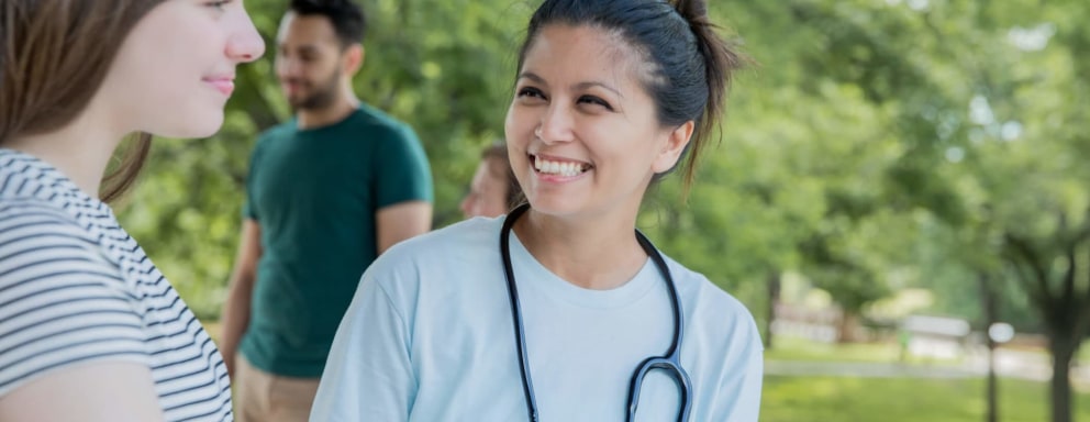 Community nurse outdoors with patient
