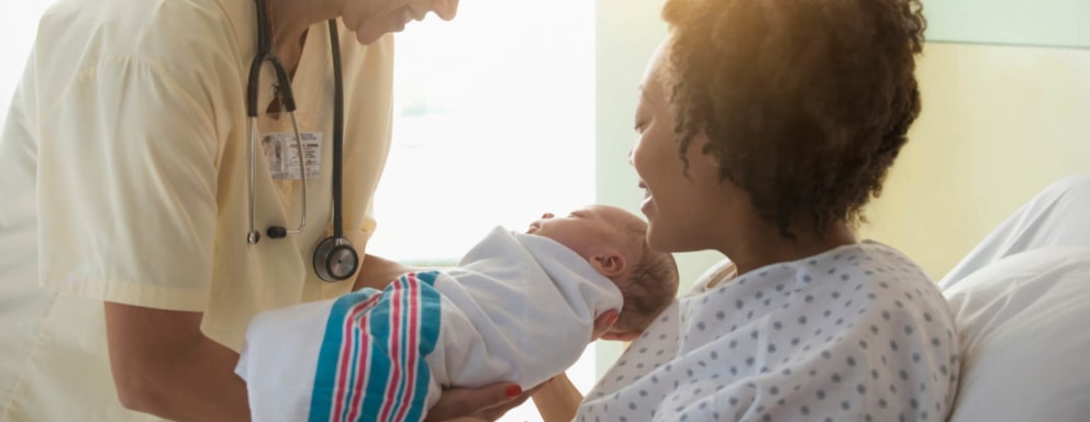 Neonatal nurse with baby and mother