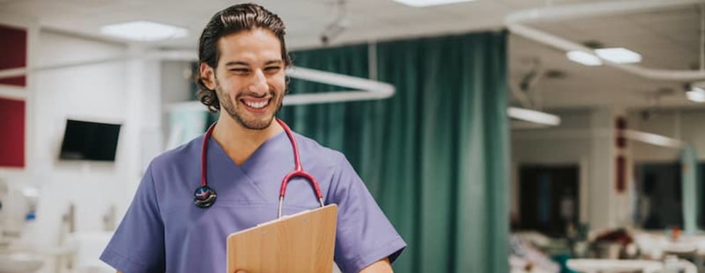 Male nurse checking on a patient