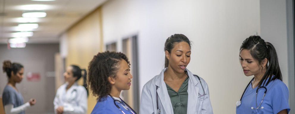 Medical professionals talking in a hallway in a hospital