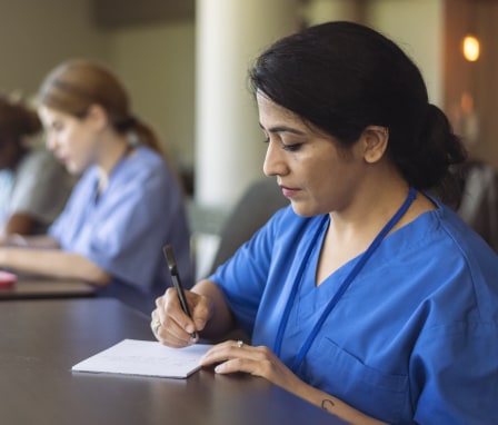 Nurses taking notes in classroom