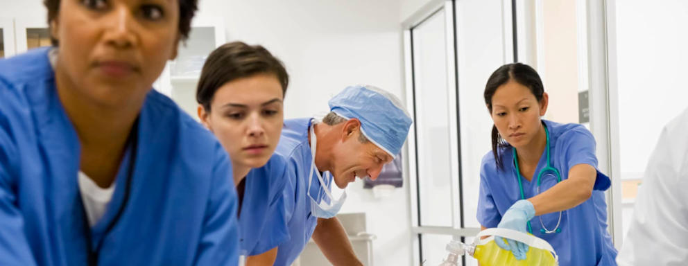 Nurses and doctor working together on a patient lying down