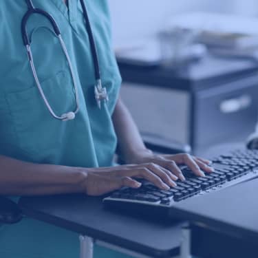 closeup of nurse hands on computer keyboard