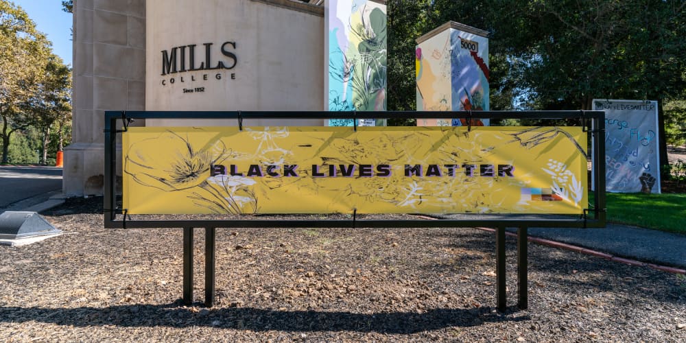 Image of Mills College campus with banner reading 'Black Lives Matter'
