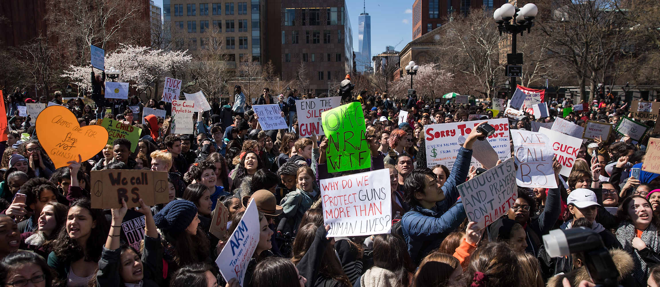 A large crowd of students holding signs protesting against gun violence outside New York University in 2018.