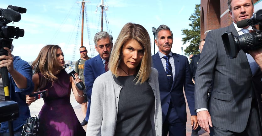 Actress Lori Loughlin and her husband, Mossimo Giannulli, leave a courthouse on August 27, 2019.