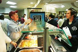 Father McShane serving students breakfast (photo from theodysseyonline.com)