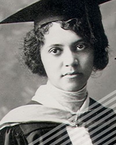 A short-haired Alice Ball wearing a graduation cap and gown looks slightly askance in a black and white photograph.