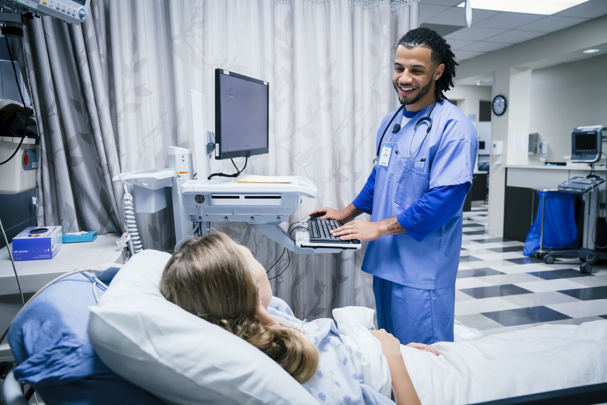 male nurse talking to patient in emergency room