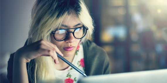 A young person conducting research on a laptop.