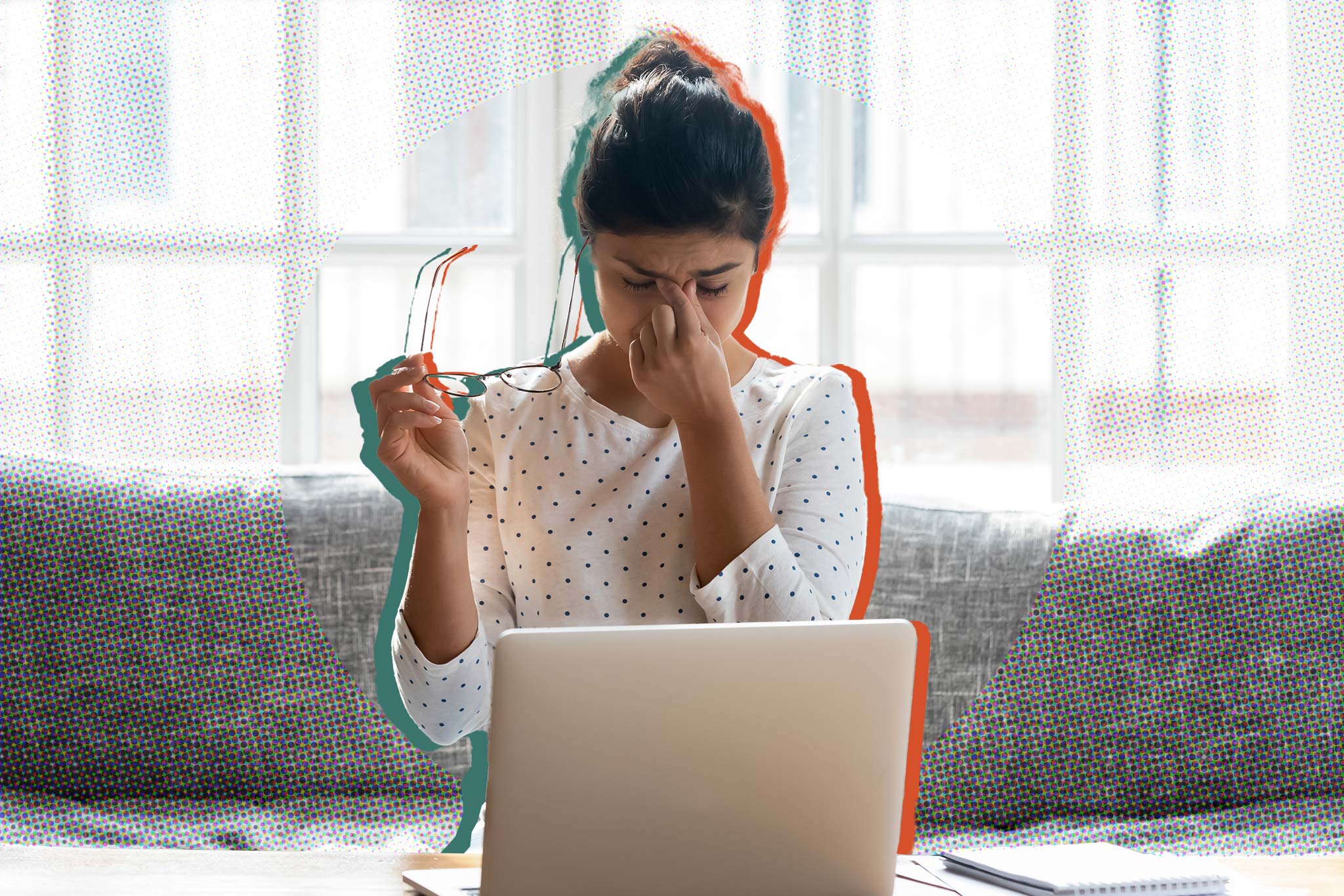 Image of student at their computer, taking off their glasses and touching their face