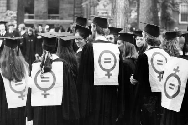 Several graduates don women's liberation signs at Harvard's commencement on June 15, 1972.