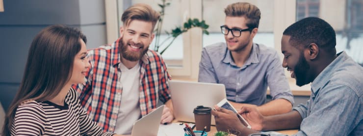 Small group of young entrepreneurs sitting at a table.