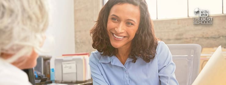 Most Affordable Online Master’s in Healthcare Administration Degree Programs hero image, happy female administrator presenting documents to doctor