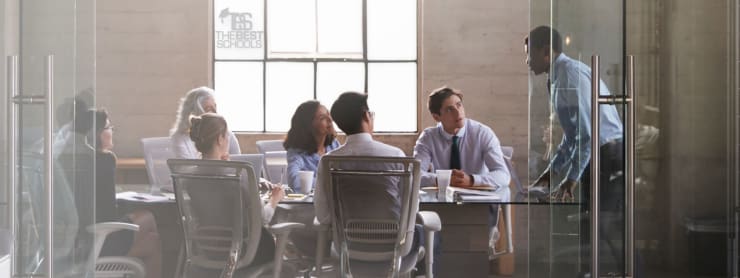 Young business people collaborating around a table. Text overlay: The 25 Best Online Bachelor in Business Management Degree Programs