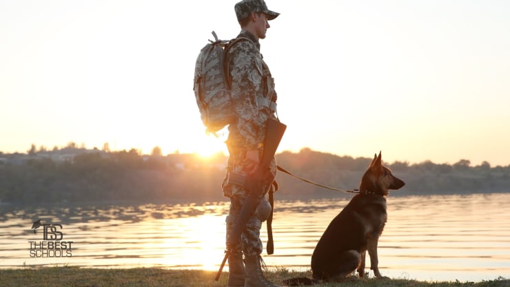 Transitioning from Military Service to Law Enforcement Hero Image: Transitioning from Military Service to Law Enforcement (military servicemember standing bya lake with a rifle and a dog)