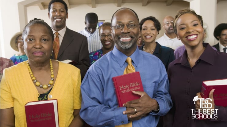 The Best Online Master's in Ministry & Pastoral Leadership Programs (image of group of people at church holding Bibles and smiling)