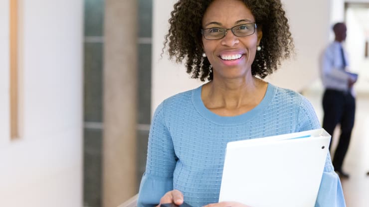 The Most Affordable Online Bachelor’s in Health Sciences Degree Programs Hero Image: The Most Affordable Online Bachelor’s in Health Sciences Degree Programs (Image of a health sciences professional with a binder and phone in their hands)
