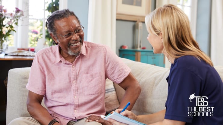 Hero image: Young woman working with an elderly man in a social work context