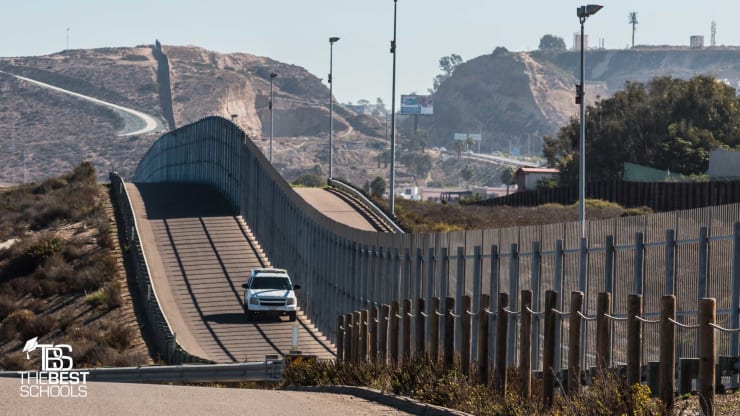 Image of Homeland Security vehicle driving along border fence