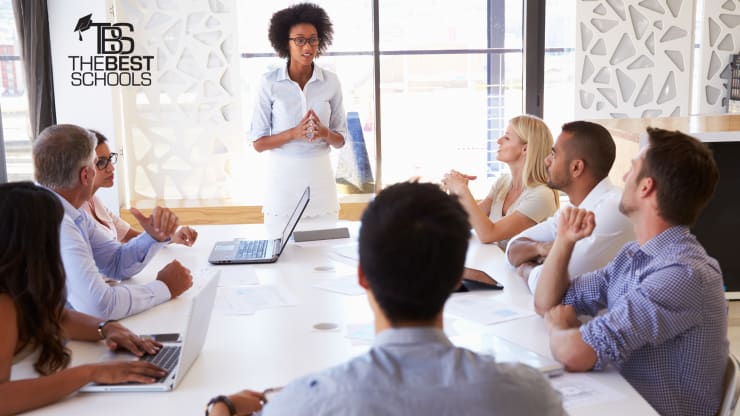 Best Online Master’s in Organizational Leadership Degree Programs (image of professional black woman presenting to colleagues at a conference room table)