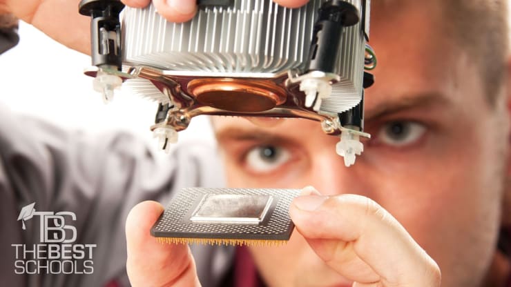 Hero Image for What Can You Do With a Computer Science Degree?: Man assembling a computer processor and processor cooling fan.