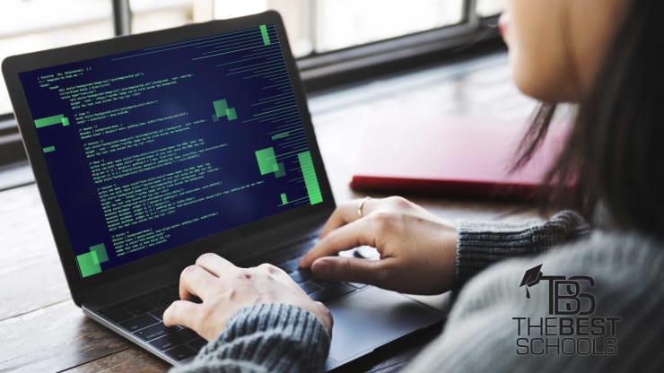 White Woman working with computer code on laptop