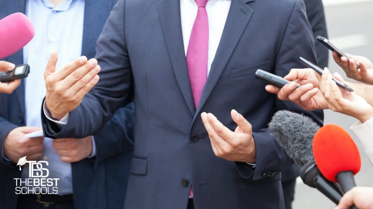 Best Online Bachelor’s in Public Policy Programs: Close up shot of the torso of a white man in a business suit who is getting interviewed