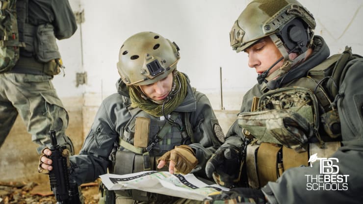 Best Online Military Studies Programs (image of two soldiers wearing fatigues in the field studying a map)