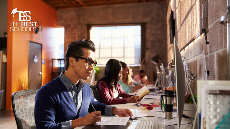 Best Online Master's in Graphic Design Programs Hero: Students sitting at computer graphic design stations