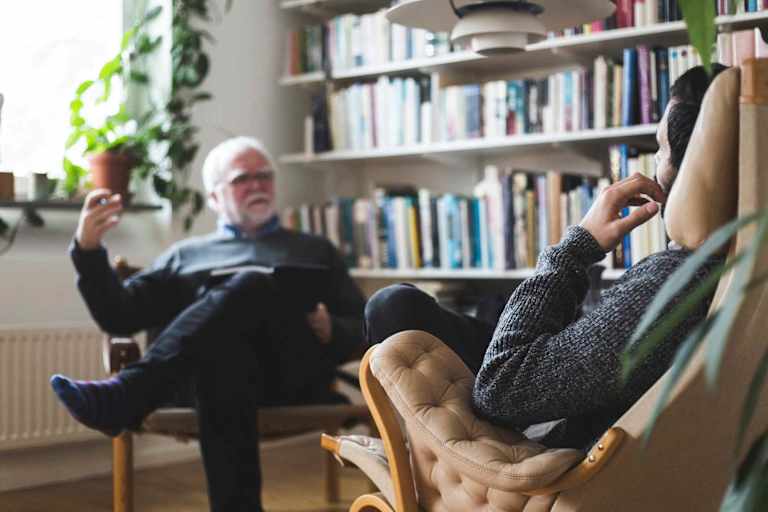 Male psychologist talking to male client